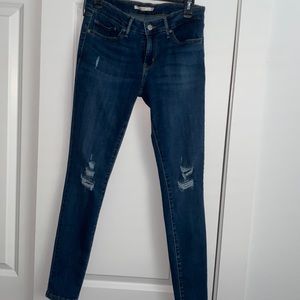 Levi’s 711 skinny jean with distressing at knees.